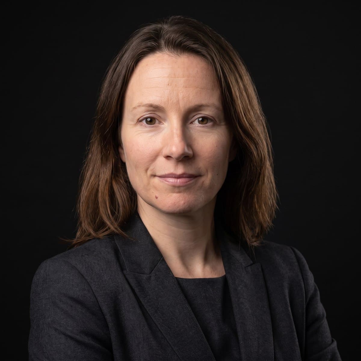 The same woman as an executive studio portrait